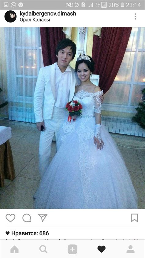 A Man And Woman Posing For A Photo In Front Of A Window Wearing Wedding