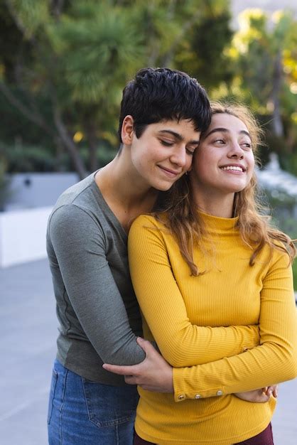 Premium Photo Happy Biracial Lesbian Couple Standing On Garden Terrace Embracing And Smiling