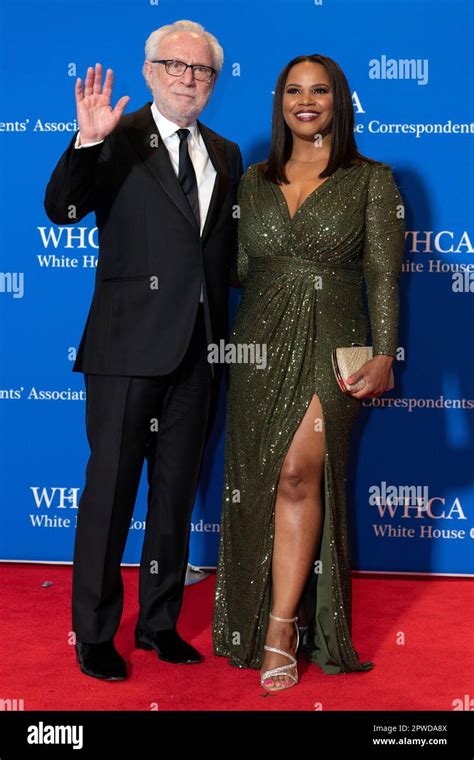 Wolf Blitzer and attorney Laura Coates pose for photographers as they