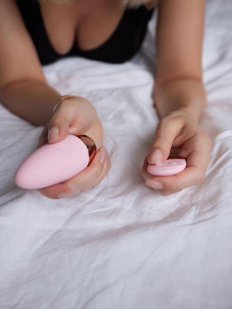 Premium Photo Beautiful Girl In Sexy Clothes Holding In Her Hands A Sex Toy For Adults