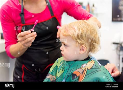 Cute Blonde Girl Having Her First Haircut Stock Photo Alamy