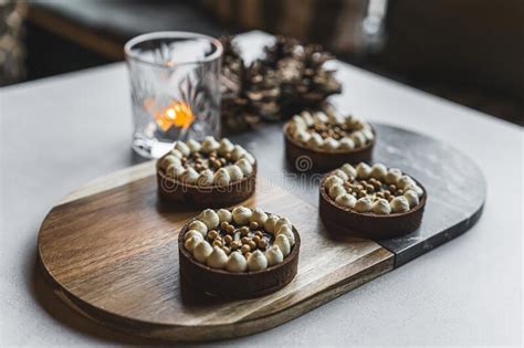 Front View Of Blonde Cheerleader In Cheerleaders Uniform Sitting On Basketball Court Posing With