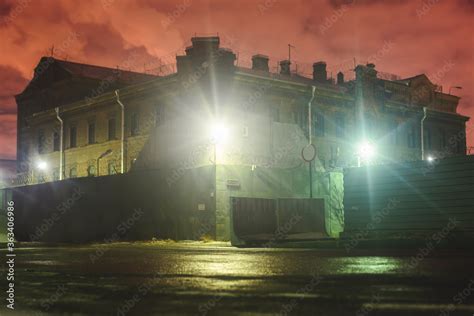 A night view of protected creepy penitentiary prison building facility ...