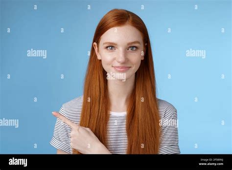 Attractive Modest Good Looking Redhead Girlfriend Acting Mature Friendly Smiling Pointing Left