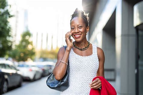 Smiling Mature Businesswoman Using Mobile Phone In Urban Setting Stock Image Image Of Downtown
