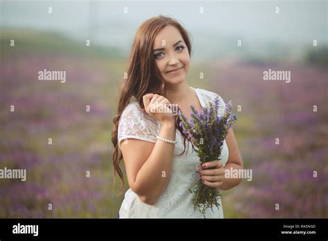 Beautifull Brunette Buxom Nubile Lady Woman With Deep Blue Eyes Posing On Field Of Spring