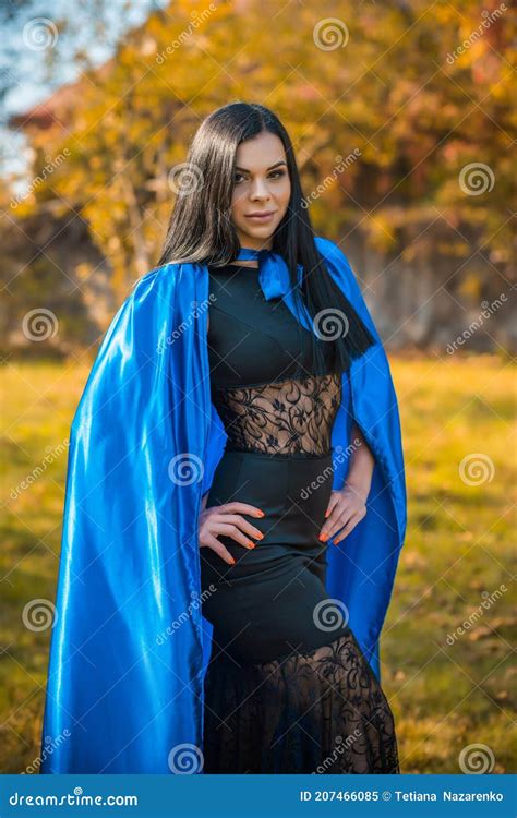 Woman In Blue Cloak And Black Dress Costumes For Ladies Stock Image