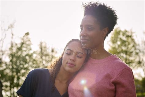 Loving Mature Mother With Teenage Daughter Enjoying Walk In Countryside