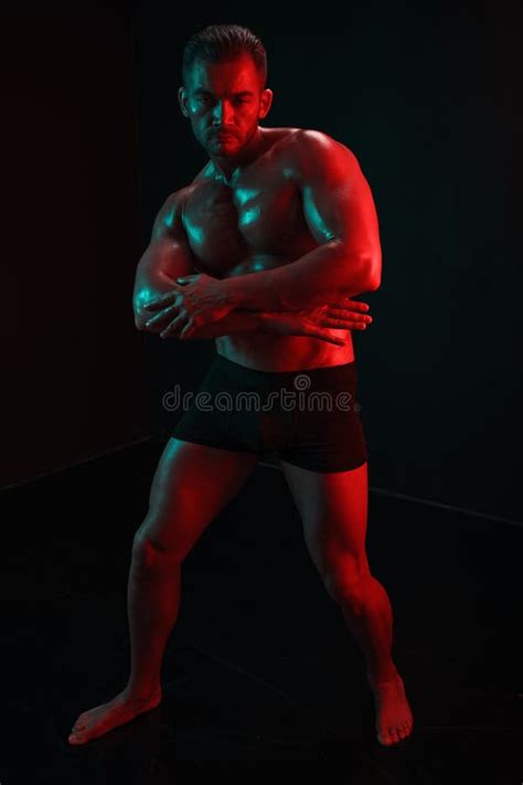 Athletic Man With A Naked Inflated Torso Holds His Hands On His Head Appearance Stock Photo