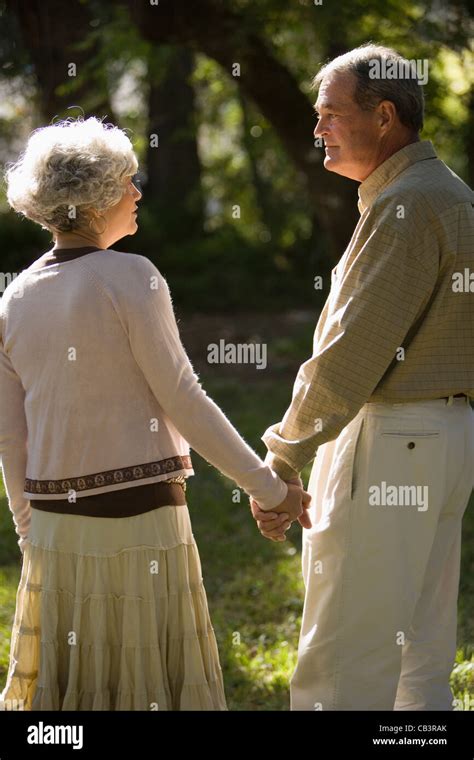 Mature Couple Holding Hands In The Park Stock Photo Alamy