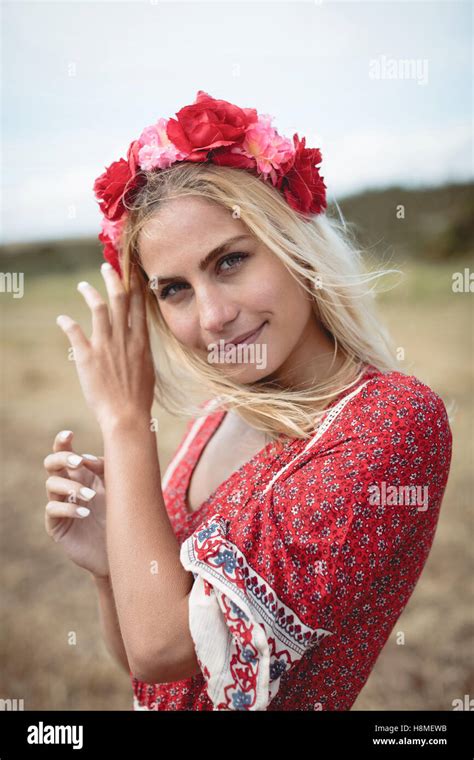 Blonde Woman Wearing A Flower Tiara Standing In Field Stock Photo Alamy