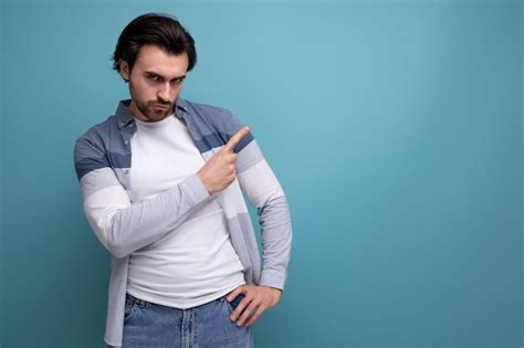 Premium Photo Energetic Smart Brunette Man Shows His Hand Studio Space