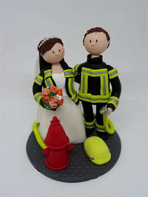 A Wedding Cake Topper With A Fireman And A Bride Holding A Flower Bouquet