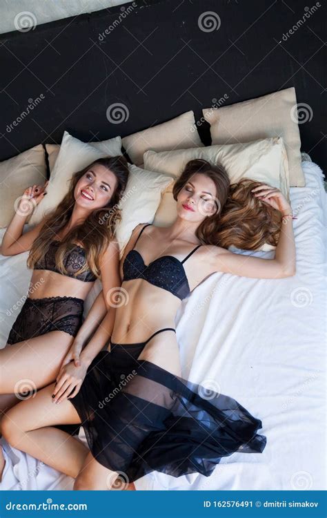 Two Beautiful Womans In Lingerie Lies In The Bedroom On The Bed Stock Image Image Of Hotel