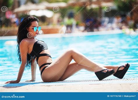 Elegant Woman In The Black Bikini On The Sun Tanned Slim An Stock Photo Image Of Blue