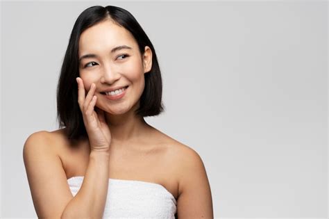 Premium Photo Portrait Of Smiling Asian Woman Touching Healthy Skin