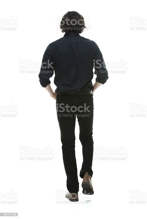 Rear View Of Walking With Hands In Pocket Stock Photo Download Image