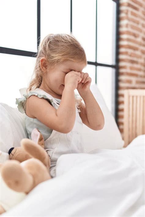 Adorable Blonde Girl Sitting On Bed Crying At Bedroom Stock Photo Image Of Morning Blanket