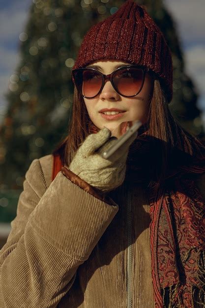 Premium Photo Woman In Warm Outerwear And Sunglasses Recording Voice