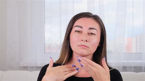 Pretty Brunette Woman Makes Herself A Facial Massage Along The Massage Lines And Points With Her