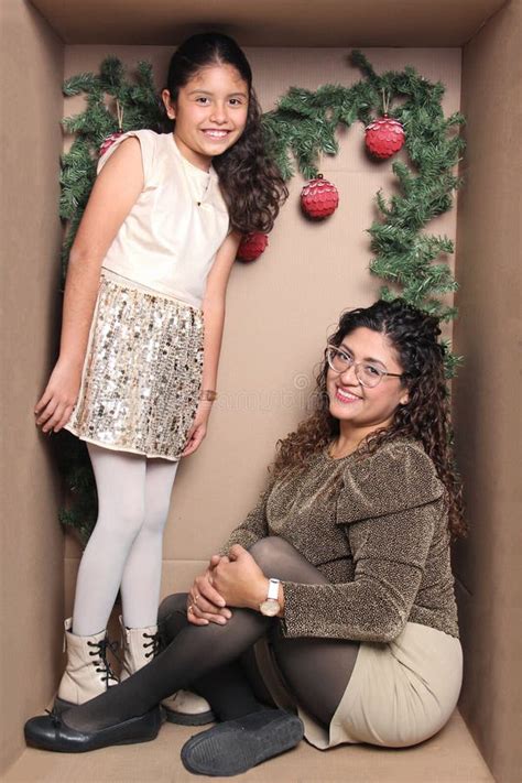 Latina Mom And Daughter With Curly Hair Inside A Decorated Cardboard Gift Box To Celebrate