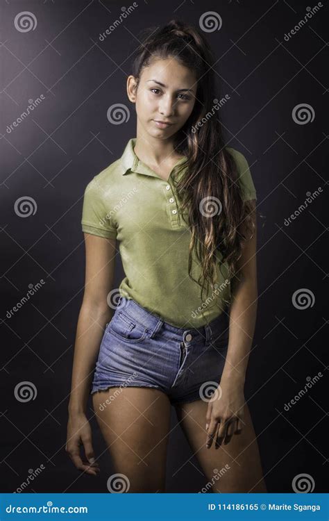 Retrato De La Mujer Latina Hermosa Joven Delante De Un Fondo Oscuro Imagen De Archivo Imagen