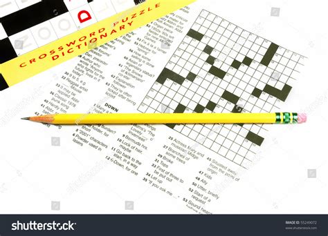 Crossword Puzzle With Crossword Dictionary And Pencil Stock Photo