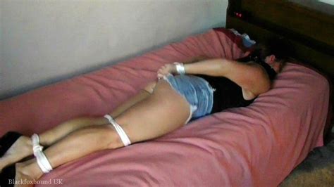 Hot Submissive Babe Laying On The Bed Tied Up Photos