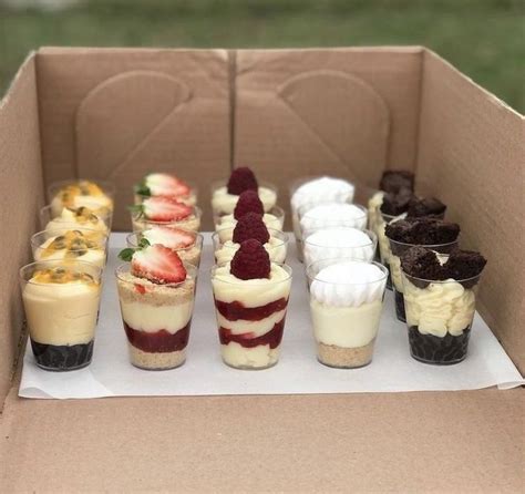 An Open Cardboard Box Filled With Desserts On Top Of Each Other And