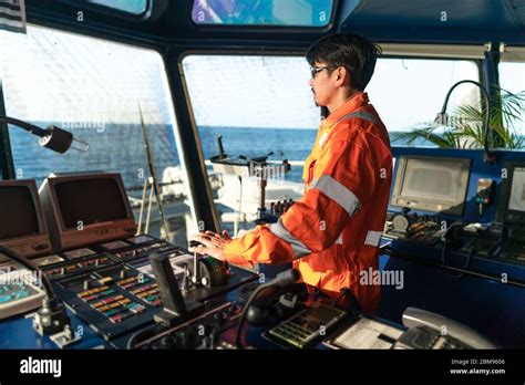 Filipino Deck Officer On Bridge Of Vessel Or Ship He Is Speaking On