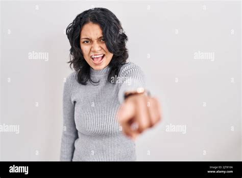 Hispanic Woman With Dark Hair Standing Over Isolated Background