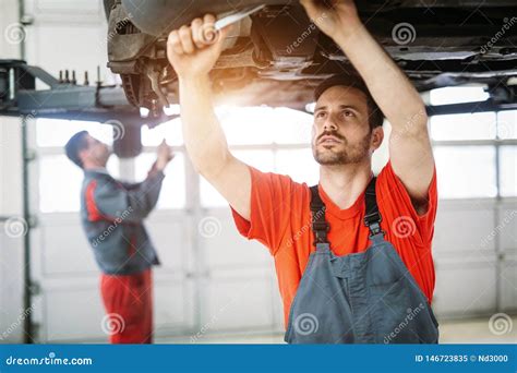 Profecional Car Mechanic Changing Motor Oil At Maintenance Repair