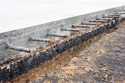 Low angle view of basement and paved cross-section under concrete road ...