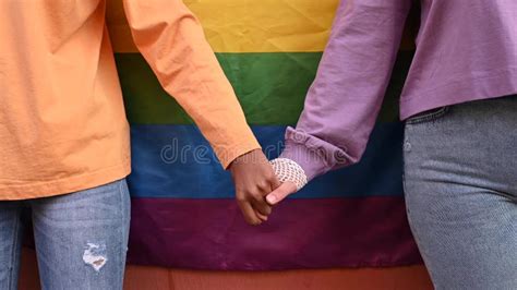 Crop Diverse Lesbian Couple Holding Hands Against Lgbt Flag Stock Video Video Of Leisure