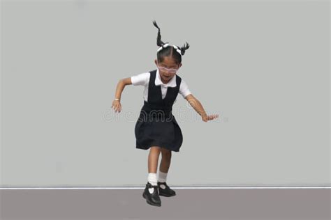 Year Old Latina Girl With Glasses Braids And Uniform Jumps With Happiness To Celebrate Back