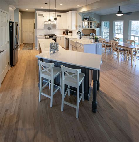 Siteline White Kitchen With Gray Island And Calacatta Miraggio Quartz