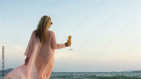 Sexy Hot Woman Walks On Golden Sunset On Tropical Beach Wet Sand Against Background Of Sea