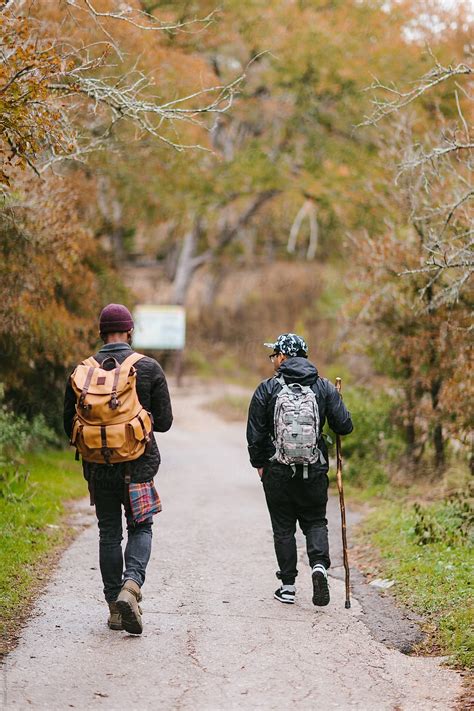 "Two Male Explorers Outside Enjoying Nature On A Cold Rainy Day." by