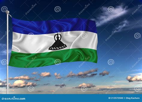 Lesotho National Flag Waving In The Wind Against Deep Blue Sky