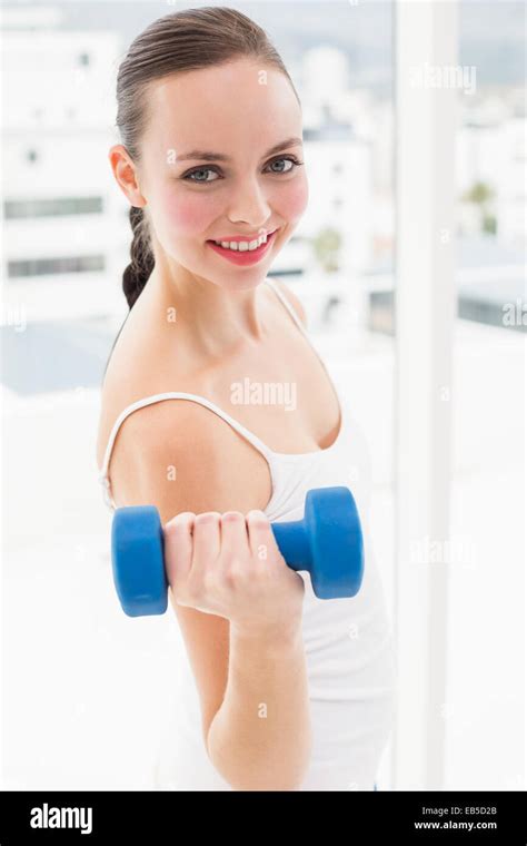 Fit Brunette Holding Blue Dumbbell Stock Photo Alamy
