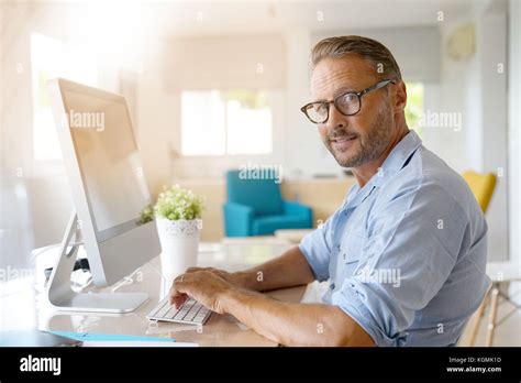Mature Man Working From Home On Desktop Computer Stock Photo Alamy