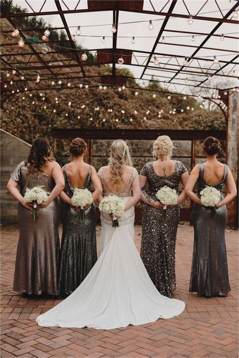 Bridesmaids with silver sequin gowns and bouquets for a winter wedding