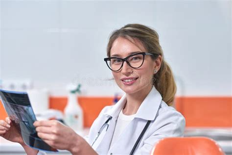 Caucasian Blonde Female Dentist Analyzing The X Ray Stock Image Image Of Gloves Health 141178511