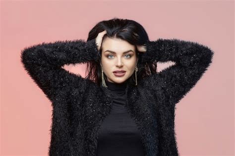 Premium Photo Charming Brunette With Long Hair On A Pink Background