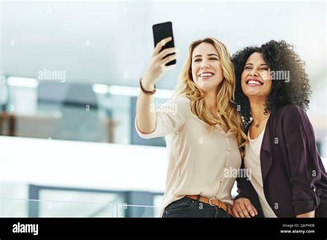 Happy Smiling And Cheerful Women Taking Selfies With A Phone While