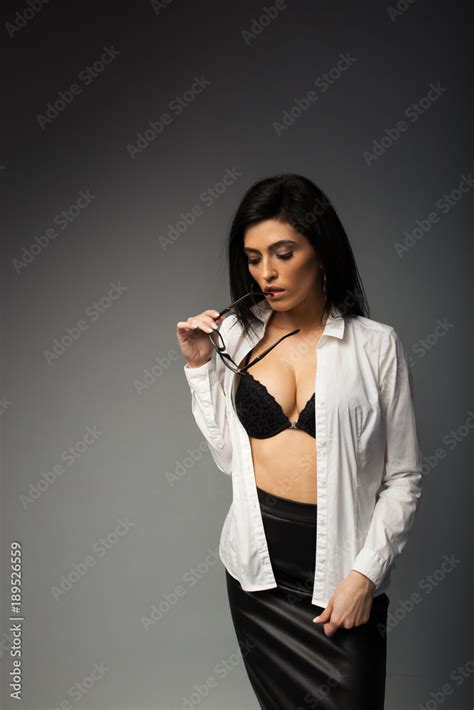Sexy Brunette With Glasses In A White Blouse With A Black Bra With A