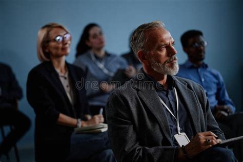 Mature Male Conference Participant Attending Conference In Group Of