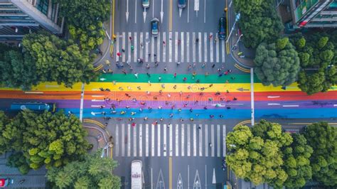 Pedestrian Road Crossing In A City Featuring A Colorful Gay Pride Flag From Above Stock Image