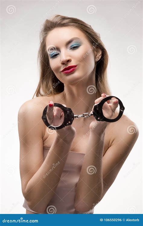 The Beautiful Blonde Red Lips Girl Smiles And Holds Handcuffs On Stock Photo Image Of Fresh