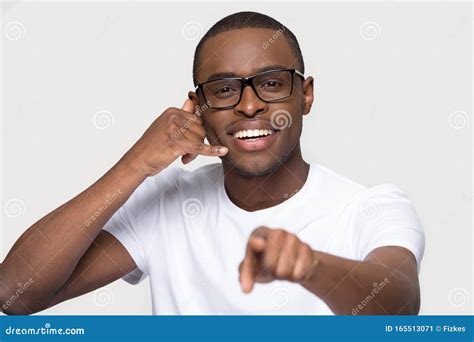 Smiling African American Man In Glasses Showing Call Me Gesture Stock